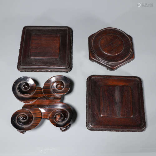 A set of 4 wooden pedestals