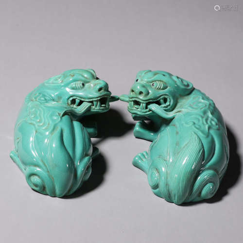 A pair of porcelain lion paperweights