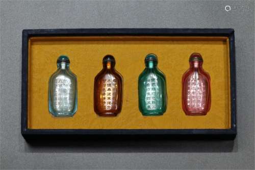 A GROUP OF FOUR GLASS SNUFF BOTTLES WITH INSCRIPTIONS