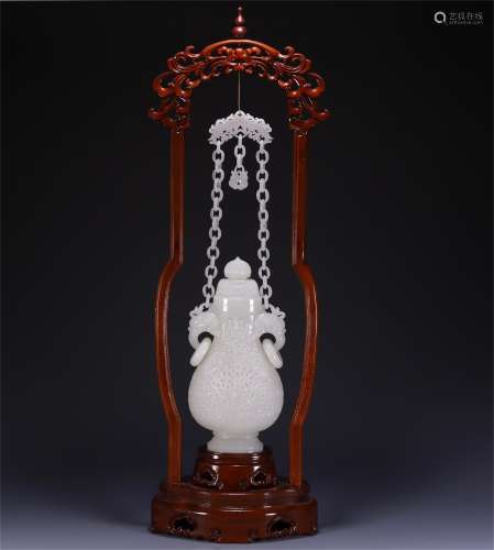 A JADE CARVED DOUBLE HANDLED HANGING VASE