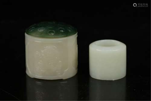 A CARVED JADE THUMB RING AND BOX