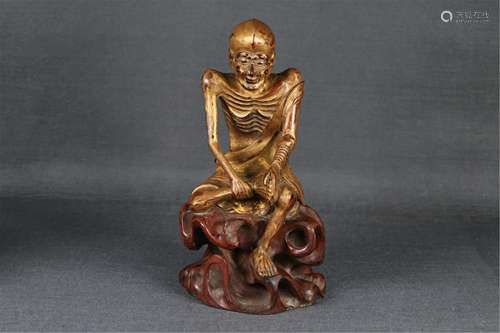 A GOLD PAINTED WOOD ARHAT STATUETTE