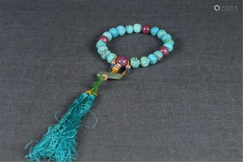 A STRING OF CARVED TURQUOISE PRAYER BEADS