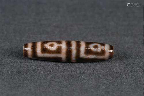 A FOUR-EYED DZI BEAD