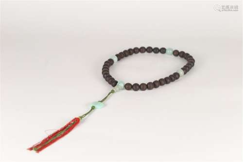 A STRING OF CARVED CHENXIANG WOOD PRAYER BEADS