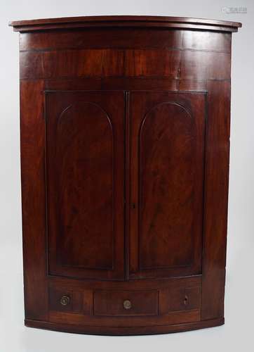 GEORGE III MAHOGANY BOWFRONT CORNER CABINET