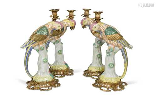 A set of four gilt metal mounted porcelain parrot candlestic...