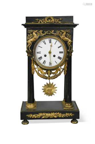 An Empire style gilt metal mounted black marble mantle clock...