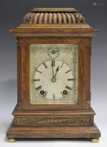 A late Victorian oak cased mantel clock with eight day movem...