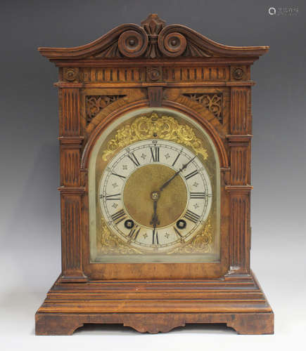 A late 19th century German walnut cased mantel clock with ei...