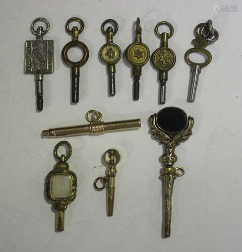 A group of four mostly Victorian watch keys, including a twi...