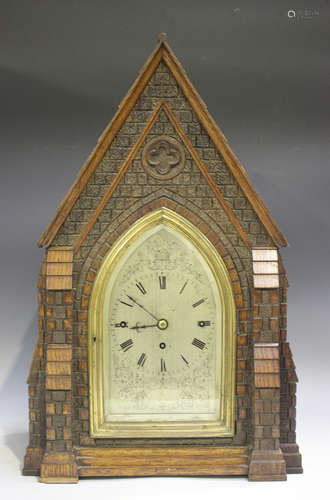 A late Victorian carved oak bracket clock of architectural c...