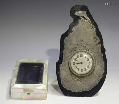 A George V silver mounted and ebonized strut clock, the surr...