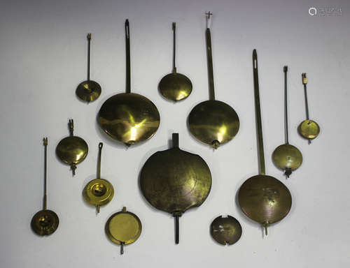 A collection of thirteen brass clock pendulums of various si...