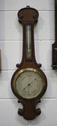 Two late Victorian wheel barometers, each with mercury therm...