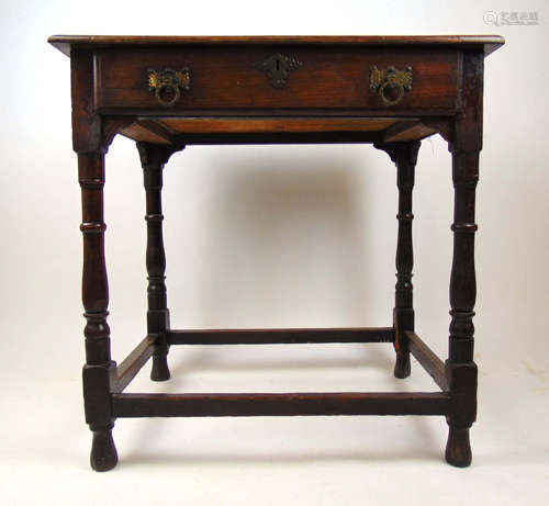 An early 18th century and later oak single drawer side table...