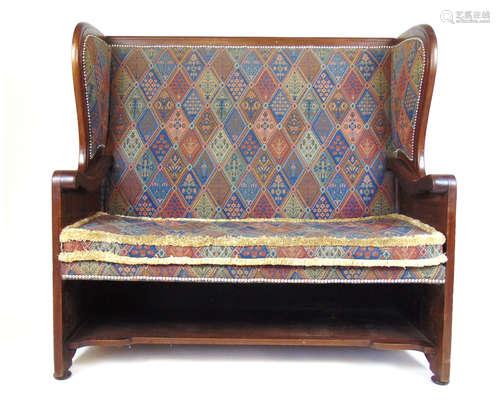 A late 19th century walnut settle with floral carved sides u...