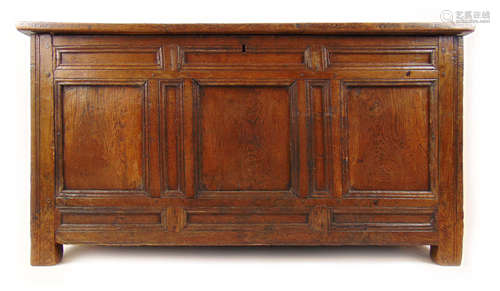 An early 18th century oak coffer, the four panel top over a ...