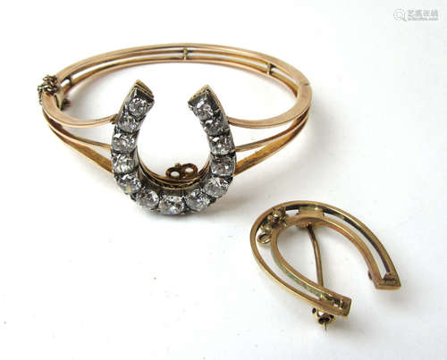 An early 20th century yellow metal hinged bracelet set with ...