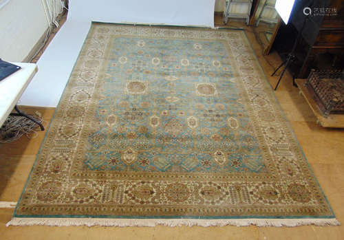 A handwoven Persian rug, the triple line border enclosing a ...