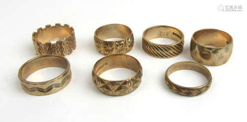 A collection of seven 9ct gold engraved band rings. Approx w...