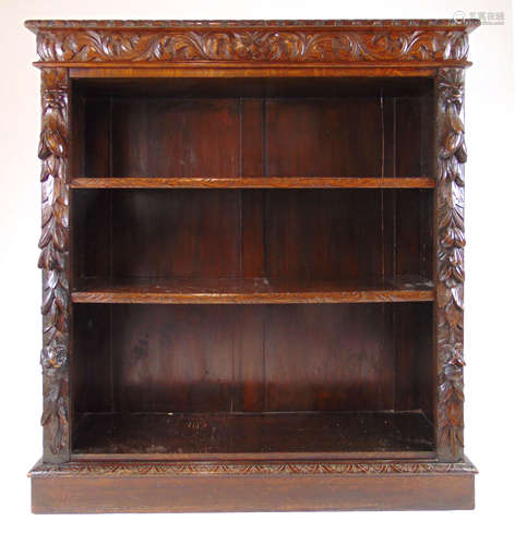 A Victorian carved oak open bookcase,