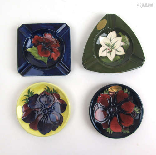 Two Moorcroft ashtrays together with two Moorcroft pin dishe...