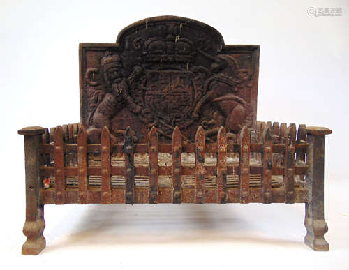 A 19th century cast iron fire grate, the bask with coat of a...