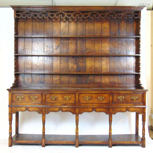 A reproduction 18th century style oak dresser, the plate rac...