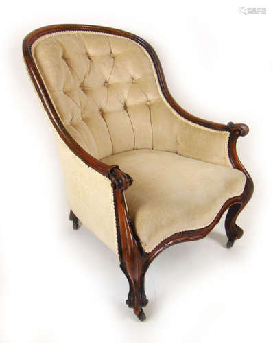 A Victorian walnut armchair upholstered in a beige button ba...