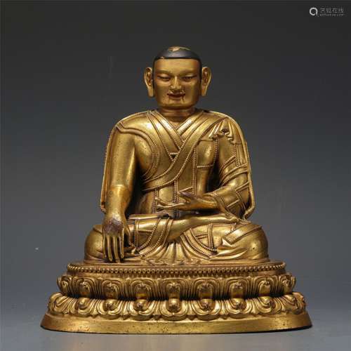 A GILT-BRONZE FIGURE OF GURU