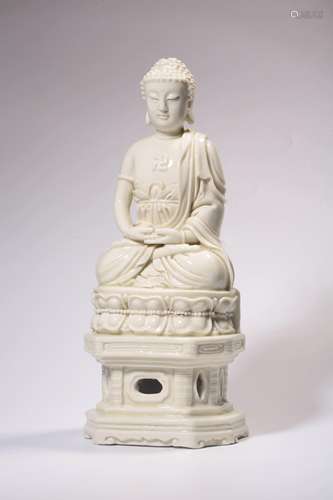 A CARVED DEHUA-GLAZED FIGURE OF SAKYAMUNI.MING PERIOD