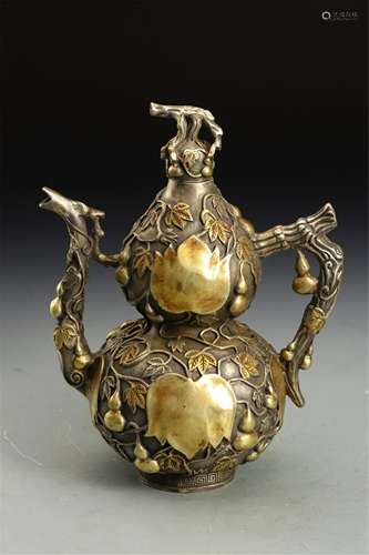 A CHINESE WHITE GILT BRONZE DOUBLE-GOURDS HANDLE…