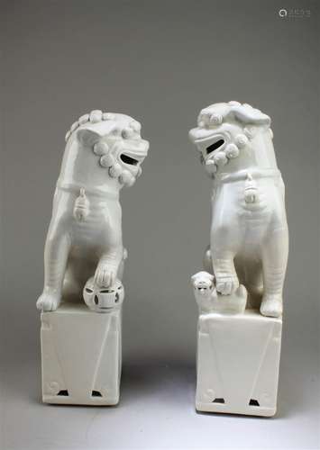 A Pair of Blanc De Chine Foo Lion Statues