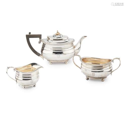 AN EDWARDIAN THREE PIECE TEA SERVICE GOLDSMITHS &