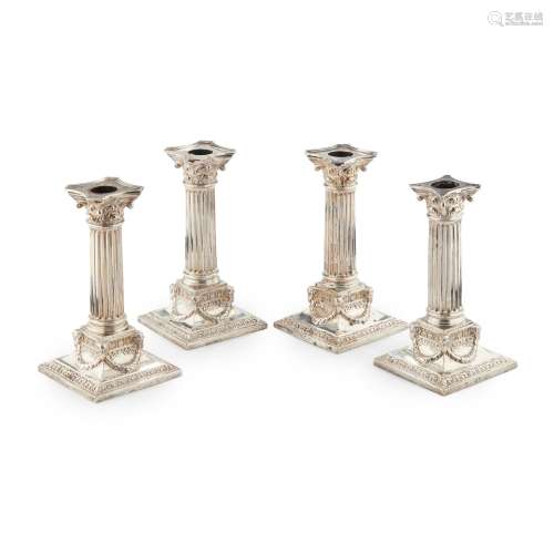 A SET OF FOUR LATE VICTORIAN TABLE CANDLESTICKS M…