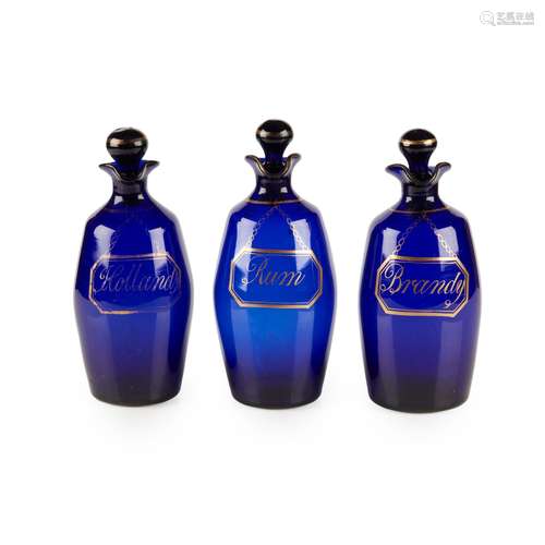 A SET OF THREE BRISTOL BLUE GLASS DECANTERS AND