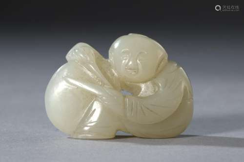 A Carved Hetian Jade Figure of Child Playing Drum