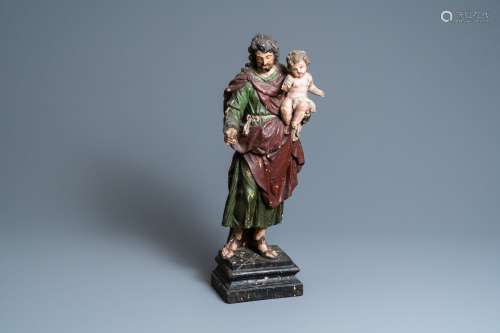 Une statue de Saint Joseph et l’Enfant Jésus en bois sculpté...