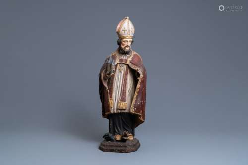 Une grande statue de Saint Amand en bois sculpté et polychro...