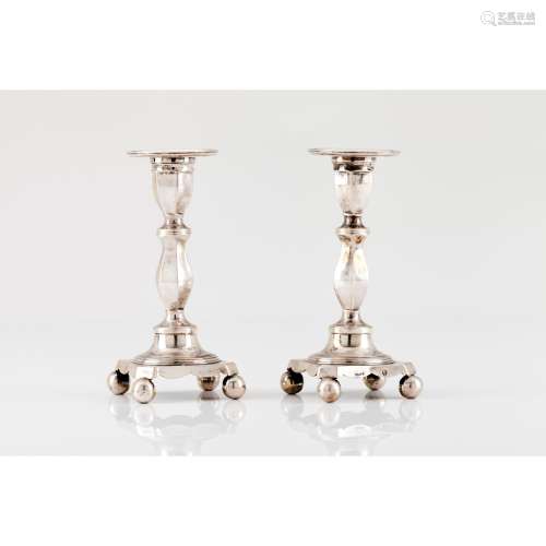 A pair of short candle sticks