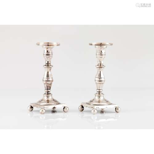 A pair of small candle sticks