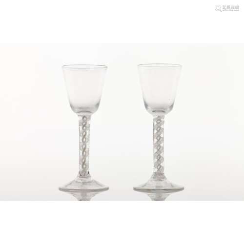A pair of tall footed glasses