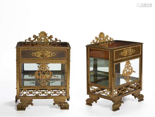 A pair of gilt-bronze glazed bedside tables