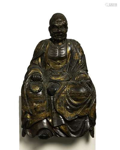 An East Asian carved wood figure