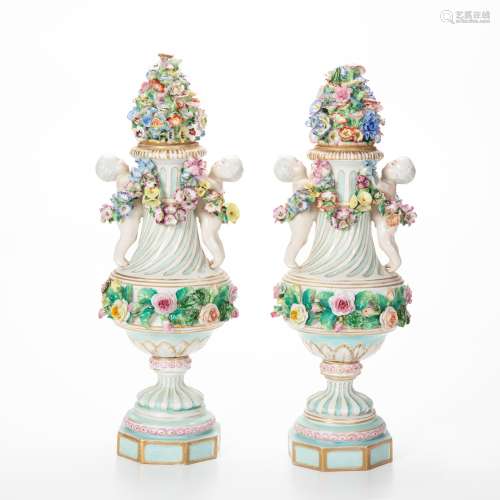 A pair of Meissen-style relief-decorated porcelain urns