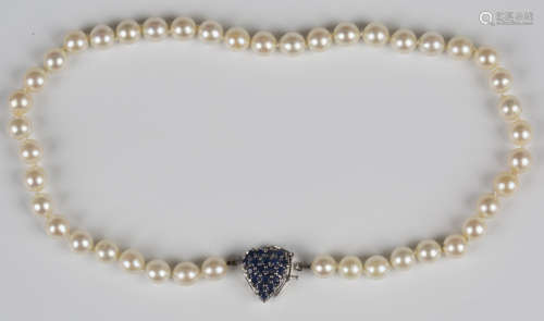 A single row necklace of uniform cultured pearls on a sapphi...