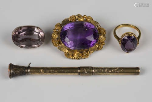 A gold ring, claw set with an oval cut amethyst, unmarked, w...