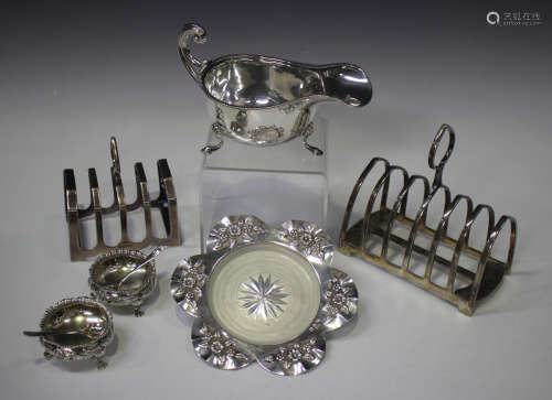 A group of silver items, comprising a sauceboat with flying ...
