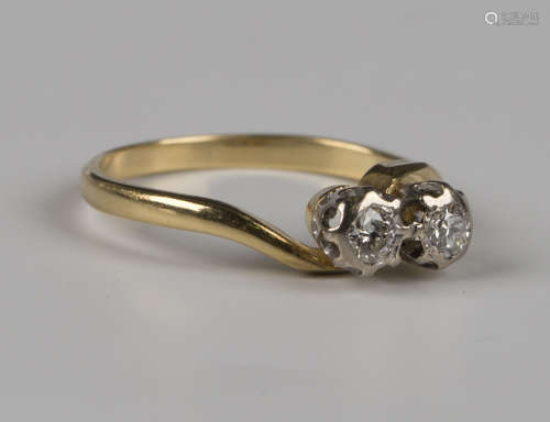 A gold and diamond two stone ring, mounted with circular cut...
